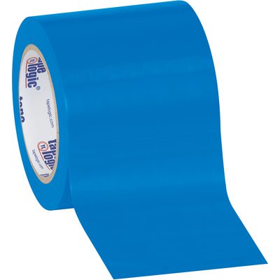 T9436B.jpg A partially unrolled 4 x 36 yds. Blue Tape Logic® Solid Vinyl Safety Tape (12 Rolls/Case) displays its smooth, glossy surface and inner text on a cardboard circle, lying on a plain white background, showcasing functionality and visibility.