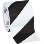 The 4 x 36 yds. Black/White Tape Logic® Striped Vinyl Safety Tape, available in a case of 12 rolls, features alternating black and white diagonal stripes, perfect for marking hazardous areas effectively.