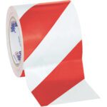 A 4 x 36 yds. roll of Tape Logic® Red/White Striped Vinyl Safety Tape showcases its vibrant diagonal stripes, striking in red and white, unfurling partially from the roll.