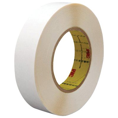T95295792PK.jpg A roll from the 3/4 x 36 yds. (2 Pack) of 3M™ 9579 Double Sided Film Tape lies on a white background, featuring a brown cardboard core with printed text and the iconic manufacturer logo. Perfect for all your sticking needs.