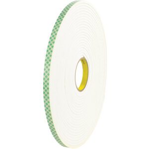 A large roll of 1/2 x 18 yds 3M Double Sided Foam Tape 4004, featuring a green checkered adhesive pattern, stands upright. The thick white-sided roll has a visible yellow core and is available in a case of 18 for versatile use.