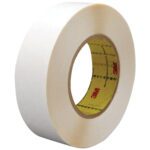 A roll of wide, white tape with a visible core, featuring 3M™ in red text, from the 1 x 36 yds. (2 Pack) 3M™ 9579 Double Sided Film Tape. Positioned at an angle, it shows both the outer surface and inner core.
