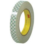 A 3/4 x 36 yds. roll of 3M - 410M Double Sided Masking Tape has a distinctive plaid exterior and a yellow inner core with red 3M. Its tightly wound, highlighting its thickness and design. (Available in 48 rolls per case.).