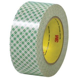 A 2 x 36 yds. roll of 3M™ - 410M Double Sided Masking Tape features a transparent tape with a green and white plaid design and a yellow core with red 3M. It reflects light brilliantly, adding to its glossy allure.