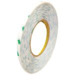A 1/4 x 60 yds. roll of 3M™ 9082 Adhesive Transfer Tape is displayed with a yellow core. The white tape features green text and lines, showcasing its side edge and substantial thickness when upright.