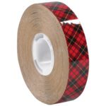 A pack of 1/4 x 36 yds. (6 Pack) 3M™ 976 Adhesive Transfer Tape is wrapped around a white core in a red and black plaid pattern with thin yellow lines, creating a classic tartan design.