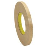 A roll of brown masking tape with a yellow core stands upright against a white background, resembling the 1/2 x 120 yds. 3M™ 9498 Adhesive Transfer Tape Hand Rolls (72 Rolls/Case), yet exuding simplistic charm in its presentation.