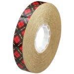 A 3/4 x 36 yds. roll of 3M™ 924 Adhesive Transfer Tape features a distinctive plaid pattern, revolves around a white plastic core, and is compactly packed with 48 rolls per case.