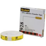 A 3M™ 928 Repositionable Adhesive Transfer Tape (3/4 x 18 yds.) sits in front of a white box with product details and a tartan-patterned yellow stripe. The tape, removable and repositionable, is offered in a convenient six-pack.