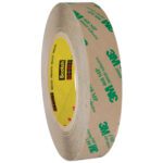 A 6-pack of 3M™ 468MP Adhesive Transfer Tape, featuring 1 x 60 yds. hand rolls with beige backing and green logos on a yellow Scotch-branded core, is displayed tilted to show its layers. Available in an efficient case for versatile application.