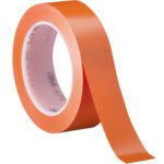 The 3M Vinyl Tape 471, sized at 1 x 36 yds., showcases a shiny orange finish and white core. Slightly unrolled, it reveals a glossy texture with printed text on the core. It comes perfectly packaged in a convenient 3-pack.