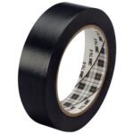 The 1 x 36 yds. Black 3M General Purpose Vinyl Tape 764 is coiled neatly, showcasing its glossy finish. The brands logo appears inside, and a checkered pattern adorns the cardboard ring.