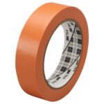 A roll of 1 x 36 yds. Orange 3M General Purpose Vinyl Tape 764 (36/Case) stands upright against a plain white background, showcasing its plaid-patterned inner core.