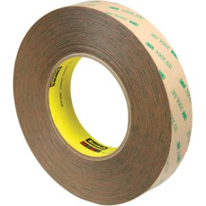 The 1 x 60 yds. 3M™ 9472LE Adhesive Transfer Tape with 300LSE text has a yellow core displaying the Scotch logo. Sold in cases of 9, it comes coiled to highlight its layers.