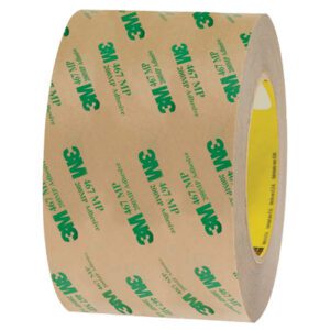 A 3 x 60 yds. roll of tan-colored 3M™ 467MP Adhesive Transfer Tape, showcasing green logos and text on its wide surface, features a yellow inner core. This roll is part of a convenient (6 Pack).