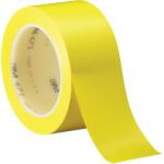 A roll of bright yellow adhesive tape is partially unrolled on a white background. The glossy surface shines and bears the label 3M 471 and Made in USA. This versatile Yellow 2 x 36 yds. (3 Pack) Vinyl Tape ensures quality performance for various applications.