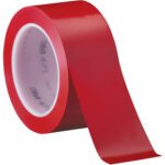 A roll of 2 x 36 yds. Red 3M Vinyl Tape 471 (24/Case) with a white inner core partially unrolls to show its smooth, glossy finish, adorned with the iconic 3M logo.
