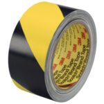 The 2 x 36 yds. (2 Pack) Black/Yellow 3M Safety Stripe Vinyl Tape 5702, tightly wound and featuring the familiar caution pattern, is ideal for hazard marking and marked with Scotch Brand Tape on the inner ring.