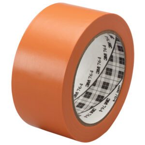 A roll of 2 x 36 yds. Orange 3M General Purpose Vinyl Tape 764, included in a 6 Pack, is angled slightly. It has a white inner core with a black plaid pattern and text, showcasing its new, smooth surface.