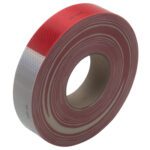 The 2 x 150 Red/White 3M™ 983 Reflective Tape (1/Case), with diamond-shaped patterns, wraps elegantly around its cardboard core, featuring alternating red and white sections that enhance visibility for safety purposes.