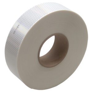 A roll of 2 x 150 White 3M™ 983 Reflective Tape, with a honeycomb pattern and brown cardboard core, is elegantly displayed on its side against a plain white backdrop.