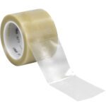 An unrolled 3 x 36 yds. clear 3M Vinyl Tape 471 shows its smooth surface, mounted on a marked white plastic core. (12 Rolls/Case).