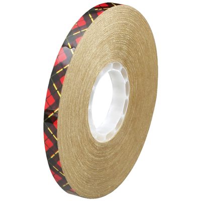 T9689246PK.jpg The 3M™ 924 Adhesive Transfer Tape, 1/2 x 11 yds. (6 Pack), features a brown adhesive surface with red and black plaid edging. It is shown on a white background, highlighting its thickness and central hole for easy mounting.