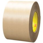 A 4 x 60 yds. 3M™ 9485PC Adhesive Transfer Tape Hand Roll, with a brown paper exterior and yellow inner core, is set against a plain white background.