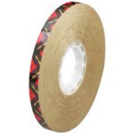 The 1/2 x 60 yds. (6 Pack) 3M™ 924 Adhesive Transfer Tape has a shiny black and red design on one side and reliable tan adhesive on the other. It features a white central core and is shown standing against a white background.