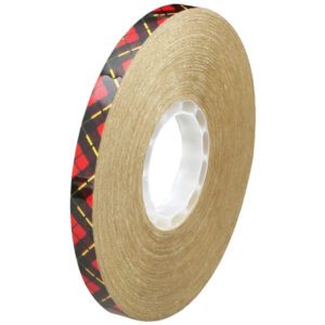 The 1/2 x 60 yds. (6 Pack) 3M™ 924 Adhesive Transfer Tape has a shiny black and red design on one side and reliable tan adhesive on the other. It features a white central core and is shown standing against a white background.