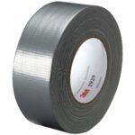 A 2 x 50 yds. roll of silver 3M™ 2929 Duct Tape (24/Case) rests on its side, with the inner label partially showing its branding and product details, highlighting its signature quality and reliability.