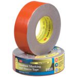 Two rolls of 3M™ 5959 Duct Tape from the 2 x 45 yds. Red (3 Pack) set—one upright and the other flat, showcasing the vibrant red tape and yellow core with product details.