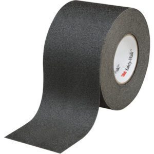 The 4 x 60 Black 3M™ Safety-Walk™ Tape - 610, partially unrolled, showcases its textured surface for grip and safety. The inside branding assures quality and reliability in each roll/case.