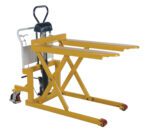 The Vestil Tote-A-Load Ergonomic Foot Pump 27 x 43 hydraulic lift table in yellow stands against a white background, featuring two forks, an ergonomic scissor lift mechanism with a foot pump, and red wheels designed for effortless heavy load lifting and moving.