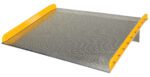 The Vestil Aluminum Dock Board Steel Curb 20K 60X60 is a durable metallic loading dock ramp with a diamond plate surface, yellow safety edges, and reinforced steel curb support. It measures 60x60 inches and offers safety and stability with a capacity of up to 20,000 pounds.