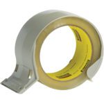 A large roll of clear packing tape comes with the 3M™ H320 Economy Carton Sealing Tape Dispenser, featuring a gray plastic holder and metal cutting edge for easy application. The yellow inner label displays the brand text.