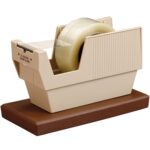 The 3M™ P52W 3 Core Table Top Dispenser features a beige design on a brown base, includes a roll of clear tape, and boasts a ribbed texture. Its visible metal cutting blade has a caution notice, offering both form and function for any tabletop workspace.