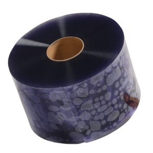 A large roll of translucent blue plastic with circular patterns is partially unwound on its side, featuring a central cardboard core. This durable roll resembles the Vestil Roll For Vinyl Strip Door with a thickness of 0.12 and a length of 200 ft.
