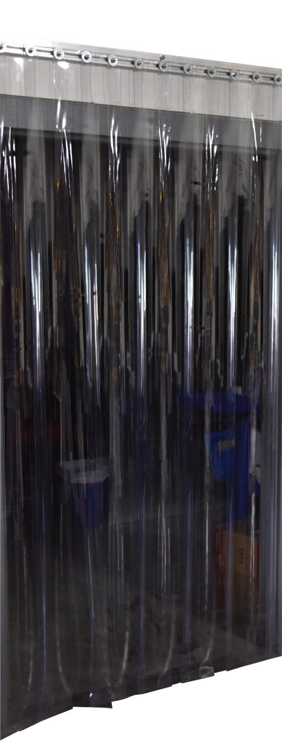 TG-1600-S-W-96-108_A.jpg Clear strip curtains, similar to those in the Vestil Vinyl Strip Door 0.16 In Std Wall 96 X 108, hang from a metallic rail, providing visibility while creating a barrier between spaces. Industrial equipment and storage items are partially visible behind the transparent strips.
