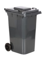 The Vestil Gray Poly Trash Can 64 Gal Capacity is a large, dark gray wheeled bin with a closed lid, two black wheels, and a side handle for easy maneuverability when viewed from an angle.