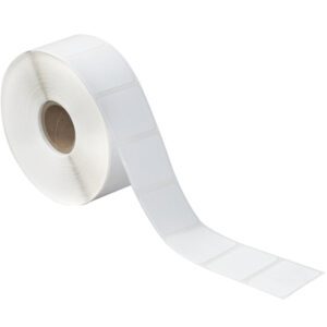 A roll of MH-USA 1 1/4 x 1 white desktop direct thermal labels on a brown cardboard core features 1380 rectangular labels that form a continuous strip, partially unspooled to reveal their glossy surface for efficient use.