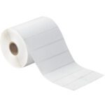 The MH-USA 4 x 1 White Desktop Direct Thermal Labels (1310/Roll) feature a white surface, rectangular shape, and are partially unrolled around a cardboard core, making them ideal for desktop printing or writing.