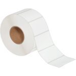 A roll of MH-USA 4 x 2 1/2 white thermal transfer labels, partially unrolled, shows the rectangular labels with rounded edges connected in a continuous strip. Each roll contains 2400 labels and has a brown cardboard core in the center.
