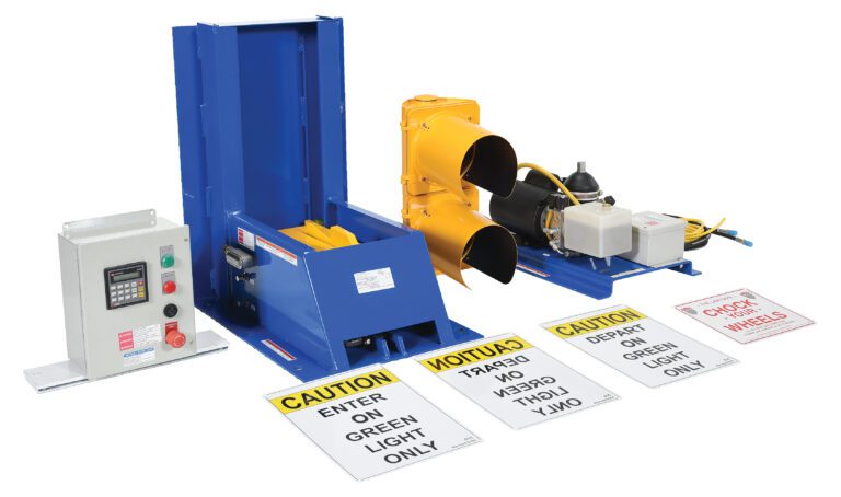 A blue vehicle restraint system and Vestil Electric Hydraulic W/Aluminum Light Pkg are included in the industrial loading dock equipment, along with a control panel. Clear visibility is ensured by a yellow dock light set, while safety is enhanced by prominently displayed caution signs.
