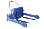 The blue manual pallet jack, with a metal handle and side support wheel, is designed for efficient pallet lifting and transport in warehouses or retail spaces, offering a sturdy 2,000 lb capacity that rivals the Vestil Tilt Master Strad DC Power 2000 lb Cap.
