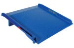 The Vestil Steel Truck Dockboard 25000 Lb, sized at 72W x 72L, features a blue metal design with a textured surface for bridging gaps between vehicles and loading docks. It includes raised edges and a secure hinge mechanism for stability.