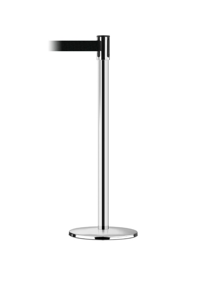 A single Vestil Tensabarrier - Indoor stanchion with a black retractable belt. It features a round, flat base for stability. Designed for indoor use, the belt extends leftward against a plain white background.
