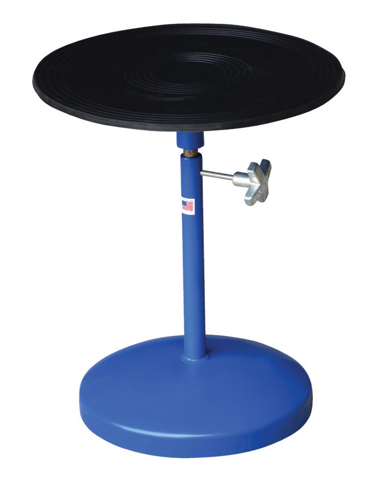 TT-18-PED_A.jpg The Vestil Turntable 18 In Dia 21 To 32 In H 300 Lb features a blue finish with an 18-inch black platform. It adjusts from 21 to 32 inches in height using a silver knob on its round base, supports up to 300 lbs, and is ideal for pottery or modeling work.