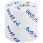 A Bedford 2-Ply Toilet Tissue roll, wrapped in white paper with Bedford Paper in blue and red text, offers comfort and reliability.