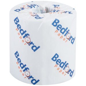 A Bedford 2-Ply Toilet Tissue roll, wrapped in white paper with Bedford Paper in blue and red text, offers comfort and reliability.